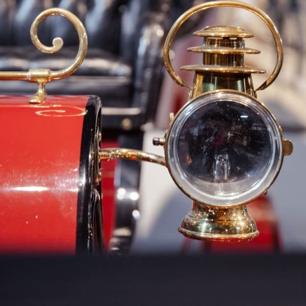 Brass headlamp on red veteran